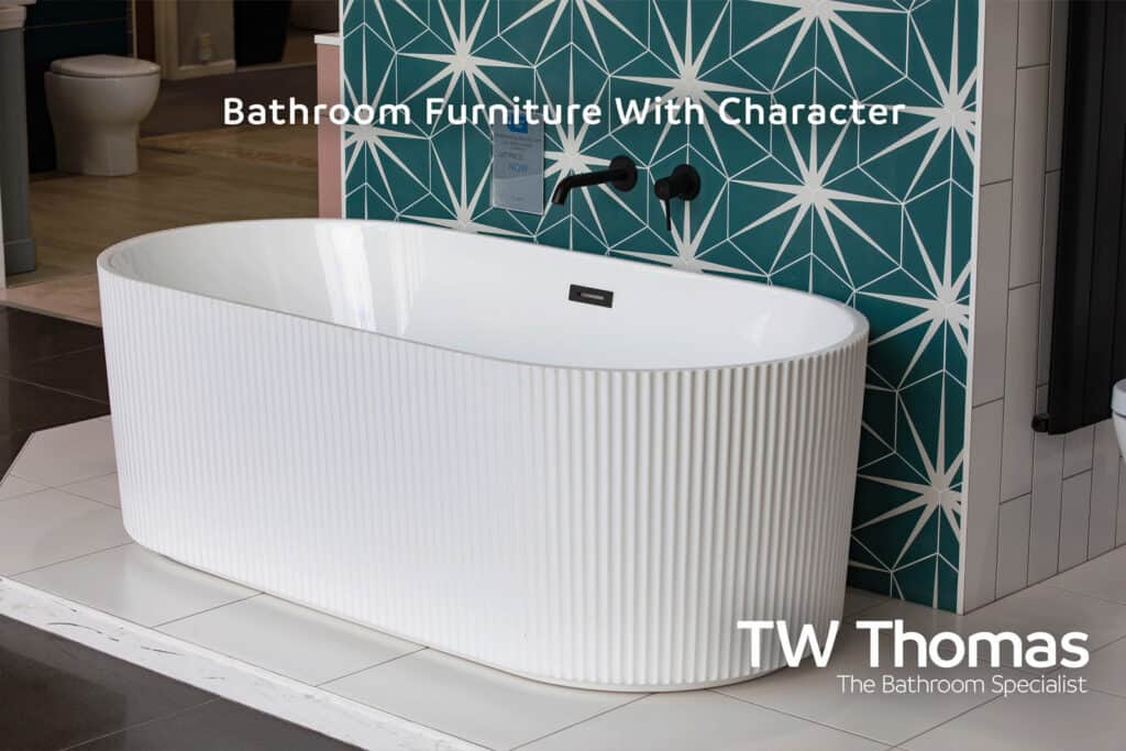 A white fluted freestanding bath against a teal star-patterned tiled wall with a matt black bath filler, captioned Bathroom Furniture With Character