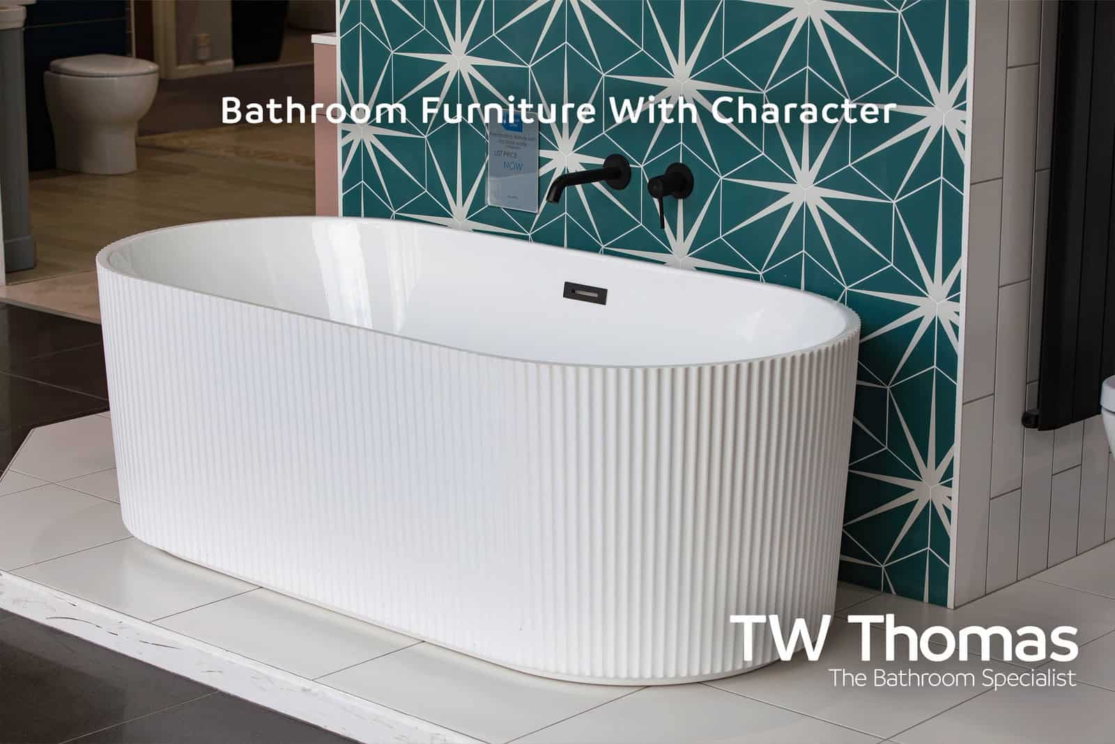 A white fluted freestanding bath against a teal star-patterned tiled wall with a matt black bath filler, captioned Bathroom Furniture With Character