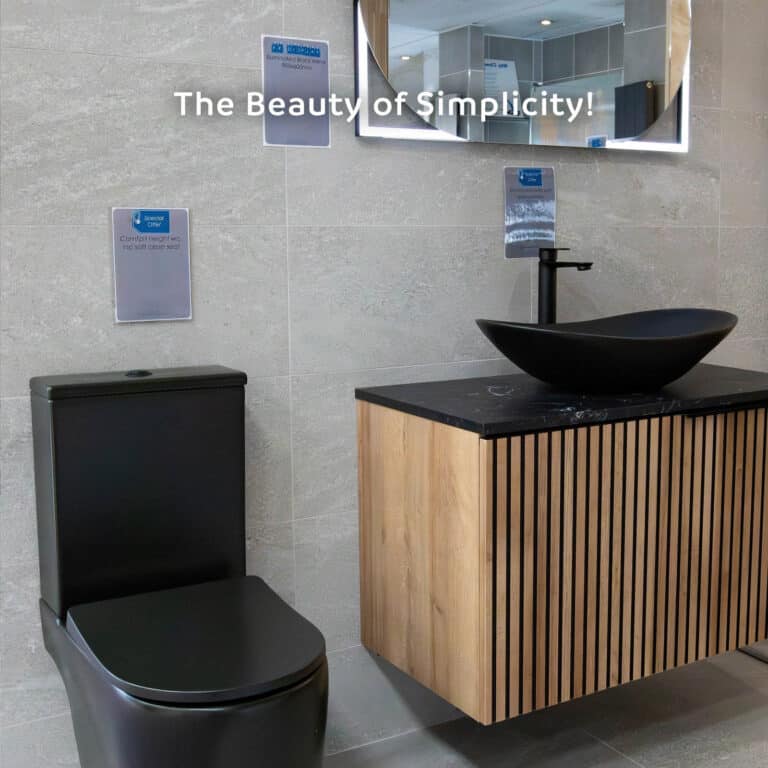 A wall-hung ribbed oak vanity with a black stone top, black oval countertop basin and matt black tap, beside a black WC, captioned The Beauty of Simplicity