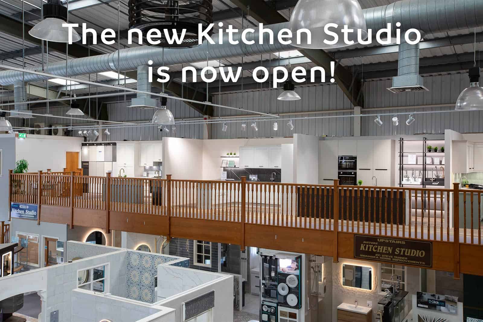 The showroom mezzanine seen from the balcony, kitchen displays above and bathroom displays below, captioned The new Kitchen Studio is now open