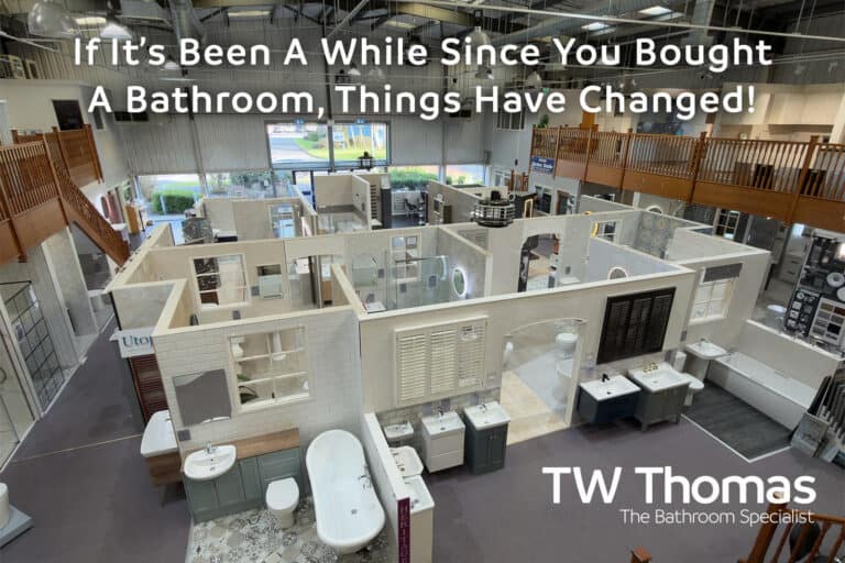 The TW Thomas showroom seen from the mezzanine with room-set displays laid out below, captioned If It's Been A While Since You Bought A Bathroom, Things Have Changed