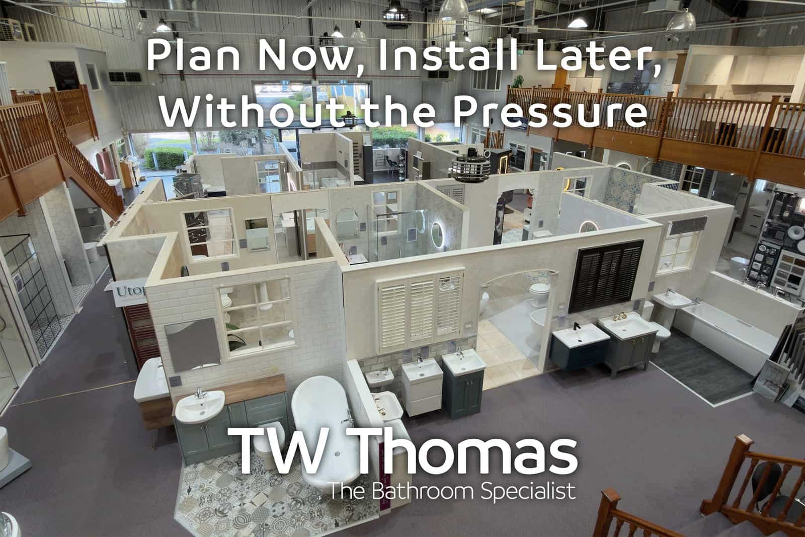 The TW Thomas showroom seen from the mezzanine with room-set displays laid out below, captioned Plan Now, Install Later, Without the Pressure