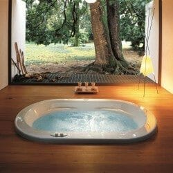 inset whirlpool bath with wooden floor surround