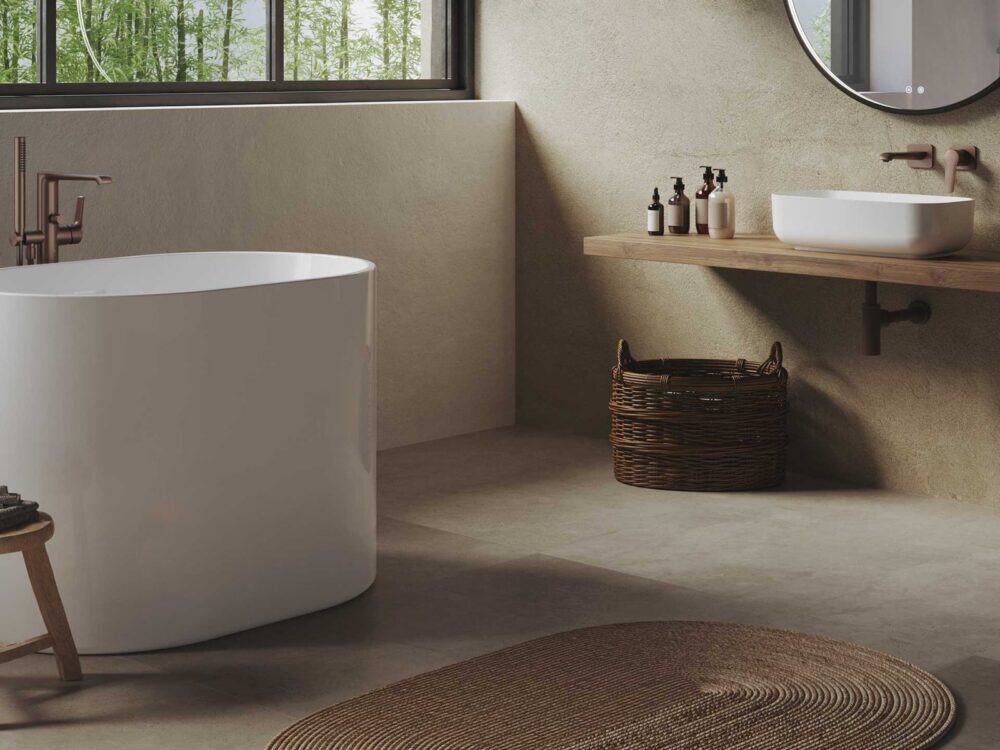 Adamsez freestanding bath in a neutral bathroom with a countertop basin and wall-hung shelf