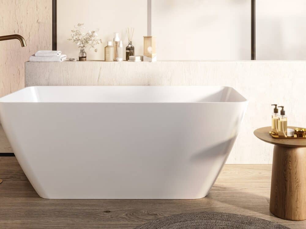 Adamsez angular freestanding bath on a timber floor with a stone shelf and a round wooden side table