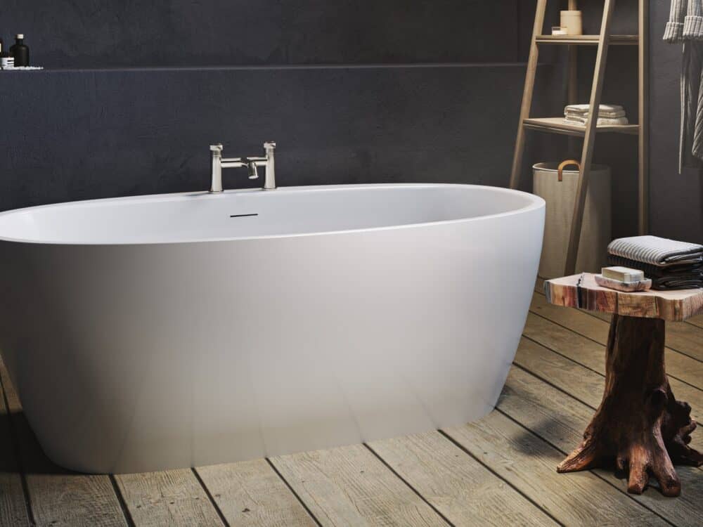 Adamsez oval freestanding bath with a chrome bath filler on a timber floor against a dark wall with a ladder shelf