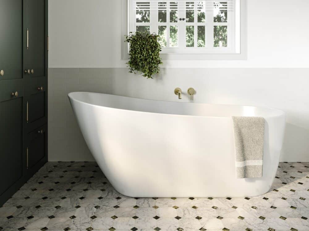 Adamsez Modena freestanding bath in a bathroom with dark green cabinetry and a patterned tile floor