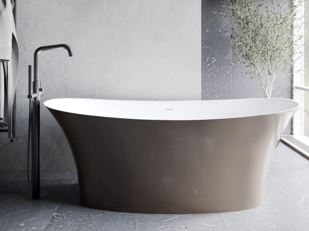 Adamsez freestanding bath in a bronze AdColour finish beside a full-height window with a matt black floor-standing mixer