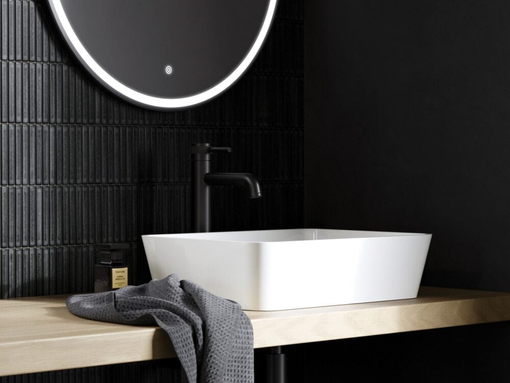 Adamsez Plazza AdCast Stone countertop basin on a timber shelf against black tiles with a round backlit mirror