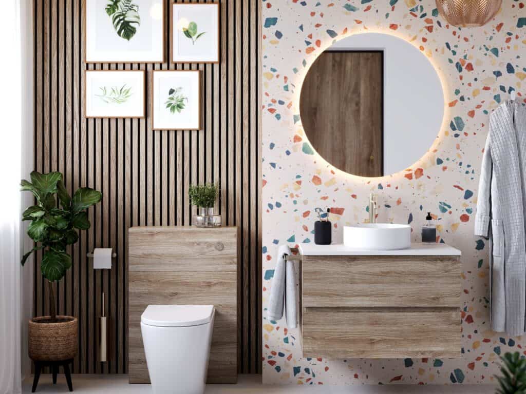 Armera Opa washed oak vanity unit and WC unit with a round backlit mirror against a terrazzo wall