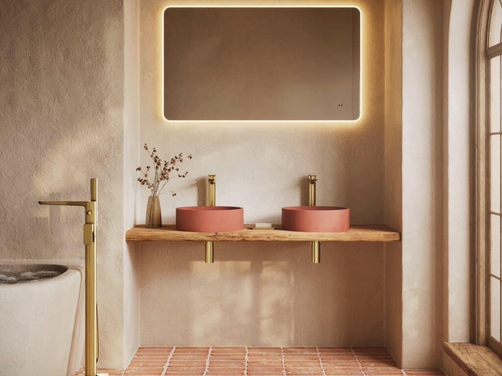 HiB Verana illuminated mirror above twin terracotta Entero basins on a live-edge timber shelf with brushed brass brassware