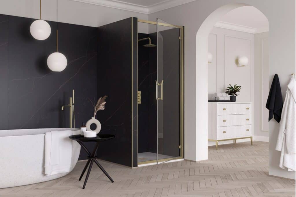 Flair ETO hinge door in an alcove with a brushed brass frame against a dark wall