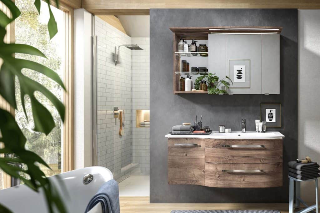 Pelipal wood-finish vanity unit and mirror cabinet in a bathroom with a walk-in shower