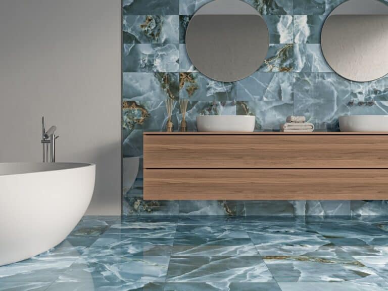 A blue marble effect tiled bathroom with a freestanding bath