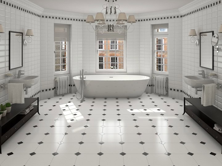 A black and white octagonal tiled bathroom floor with a roll top bath
