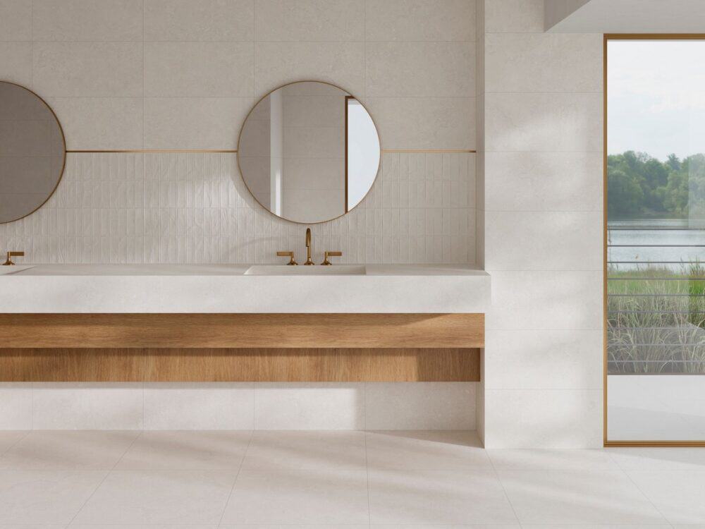 A fluted tiled wall behind twin basins and round mirrors