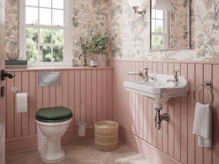Burlington towel ring, WC roll holder and brush holder in a pink panelled cloakroom with a wall-hung basin and green-seated WC