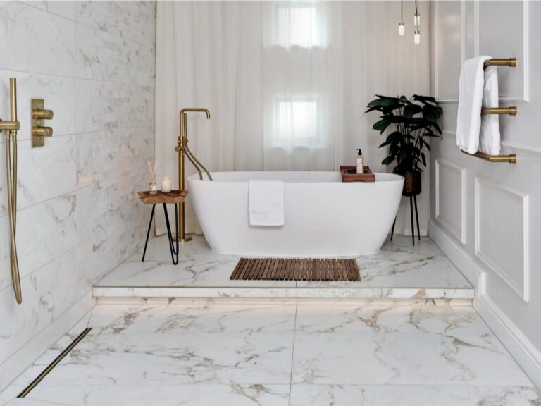 A marble effect porcelain bathroom with a freestanding bath