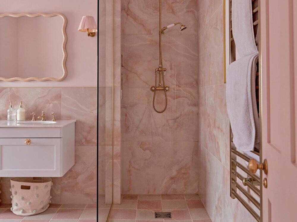 A pink marble effect porcelain shower and basin