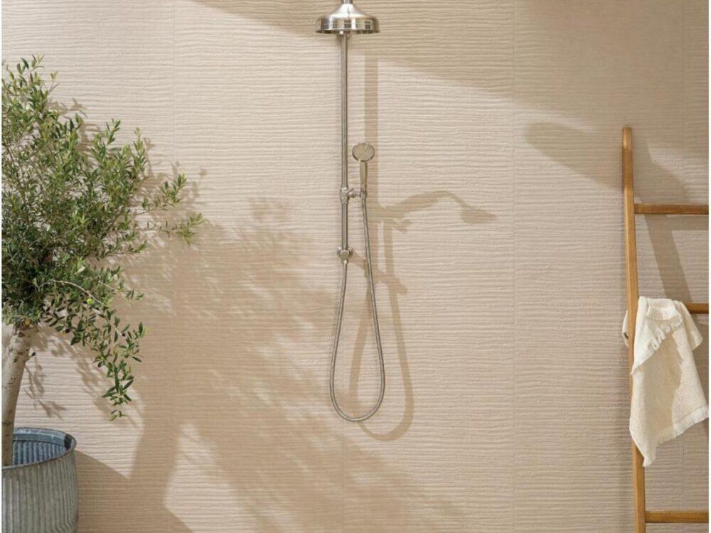 A textured plaster effect tiled shower wall