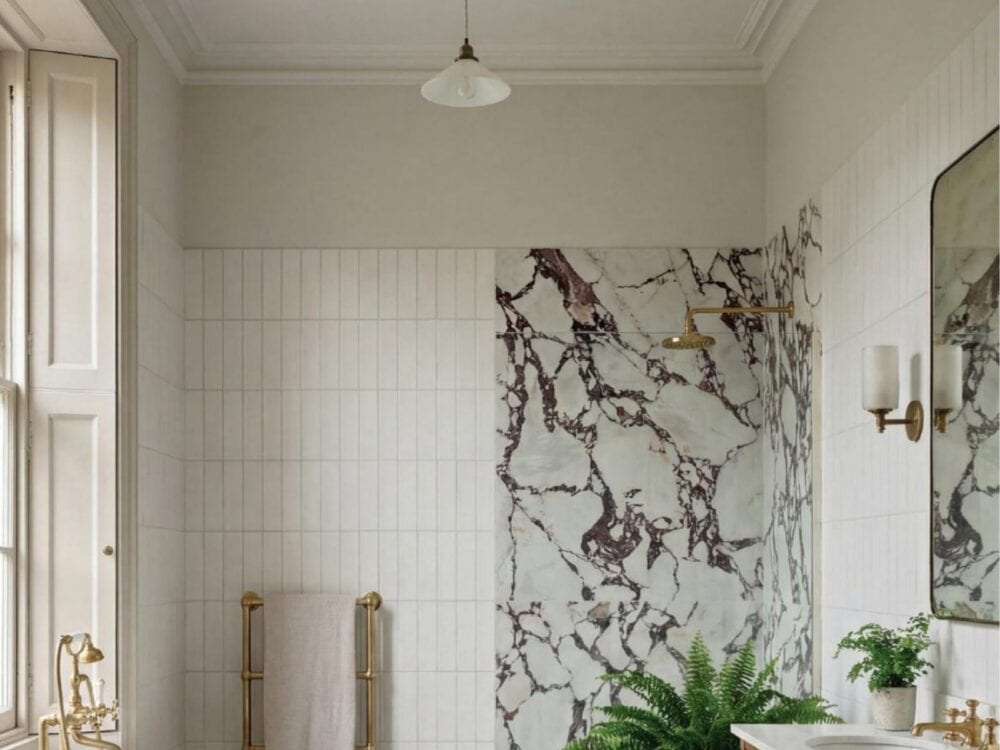 A veined marble effect wall beside a freestanding bath