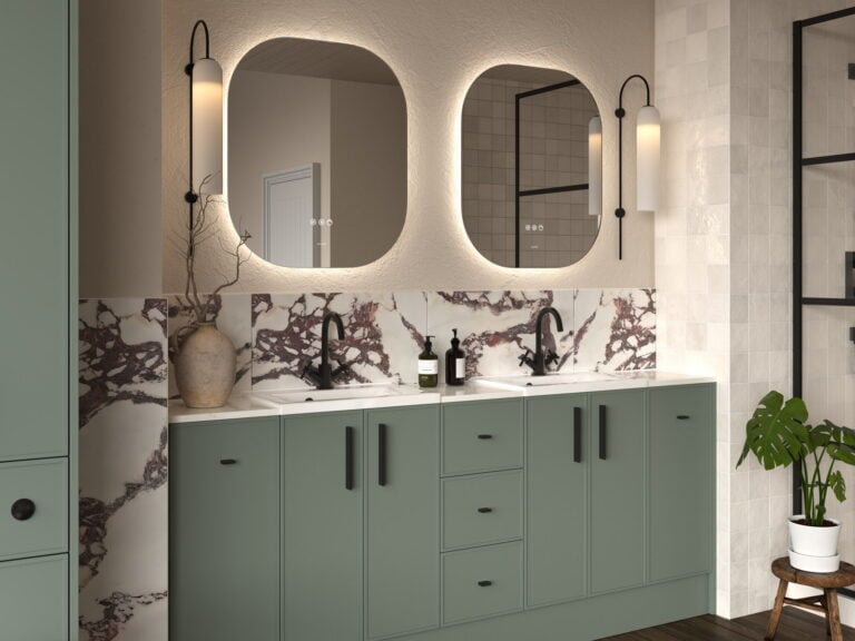 Calypso Dartmoor fitted furniture in soft green with twin basins, backlit mirrors and a marble splashback
