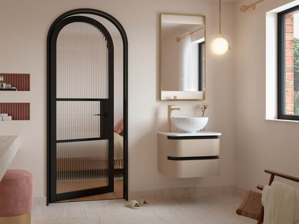 Calypso Diamante curved wall-hung vanity with a countertop bowl beside an arched fluted screen