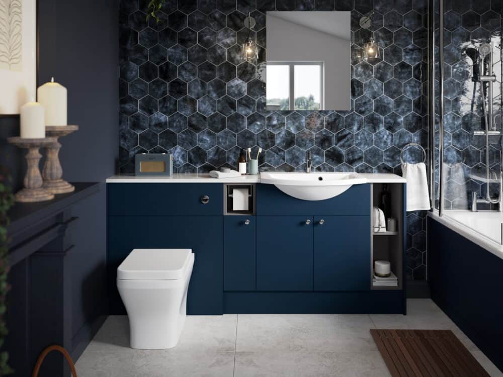 Calypso Brecon fitted furniture in marine blue with a back-to-wall WC and basin against blue hexagonal tiles