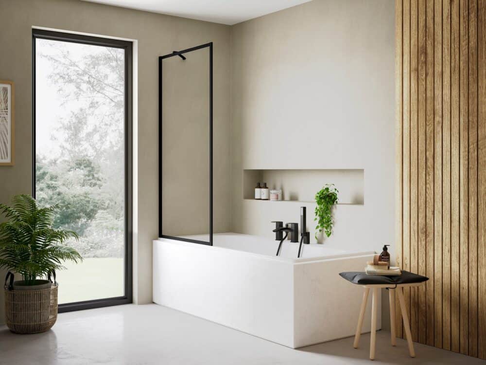 Flair AYO 8mm framed bath screen in black over a bath, against slatted timber