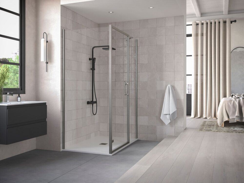 Flair AYO wetroom panel with brushed brass angle bar against black tiles