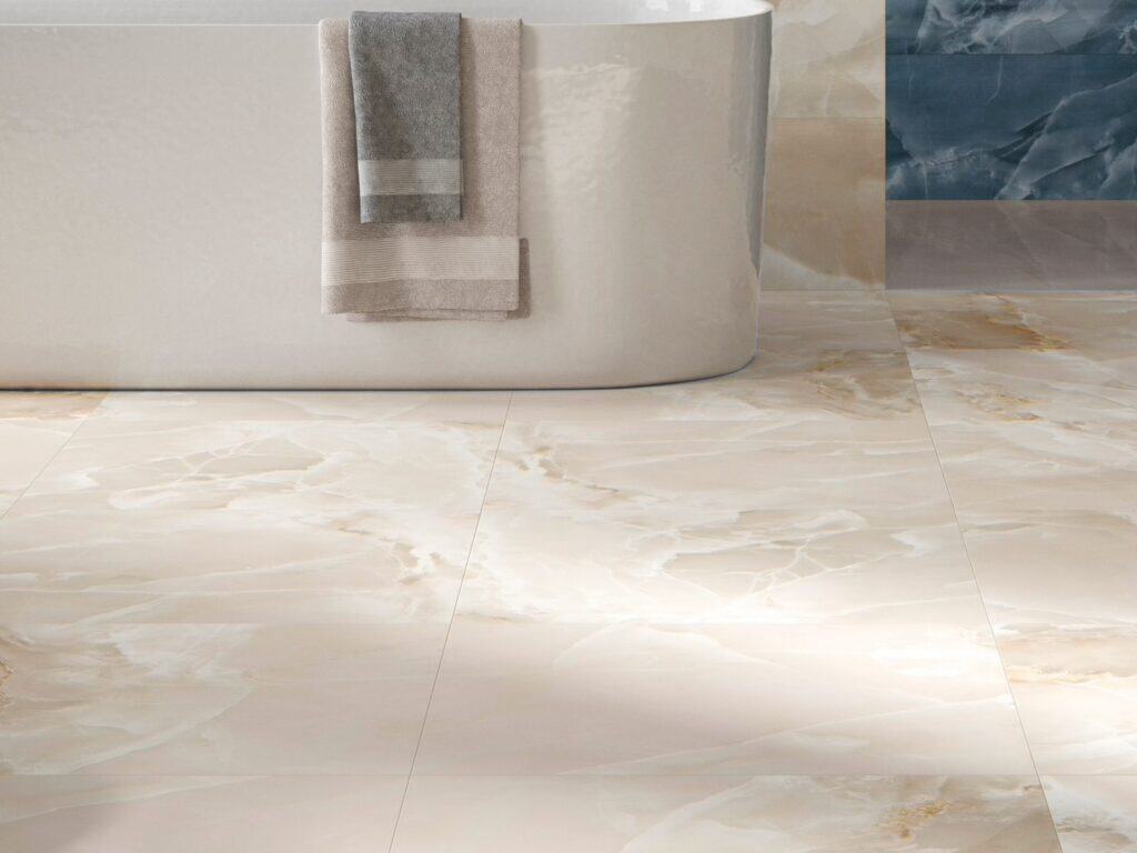 Ivory marble-effect floor tiles around a freestanding bath