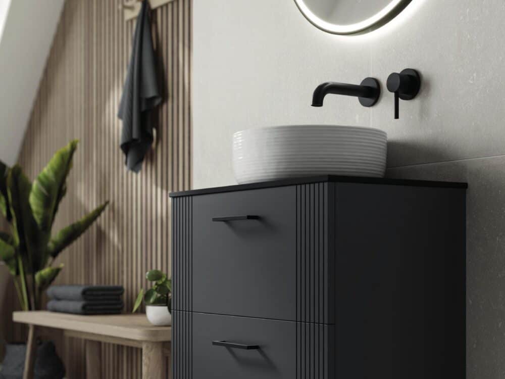 HiB Fabrica wall-hung unit in dark grey with a fluted countertop basin and a round LED mirror