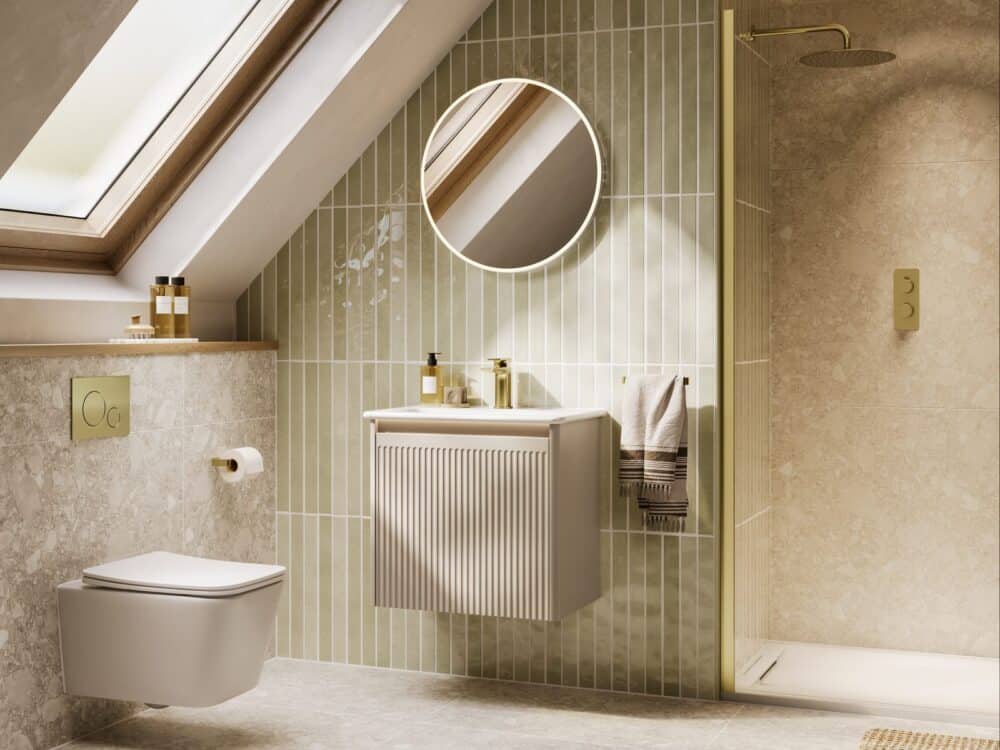 HiB Vale round mirror with a wall-hung basin and toilet against green tiles in a loft bathroom