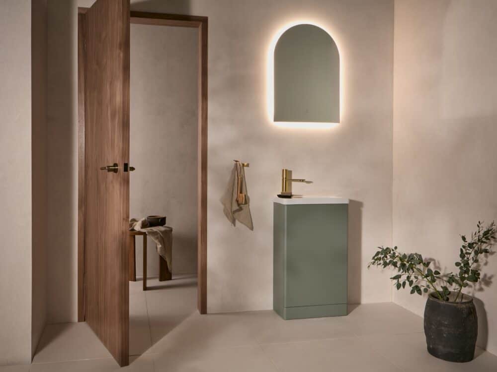 hib.inspire Catlin handleless cloakroom unit in Eucalyptus Green with an arched mirror