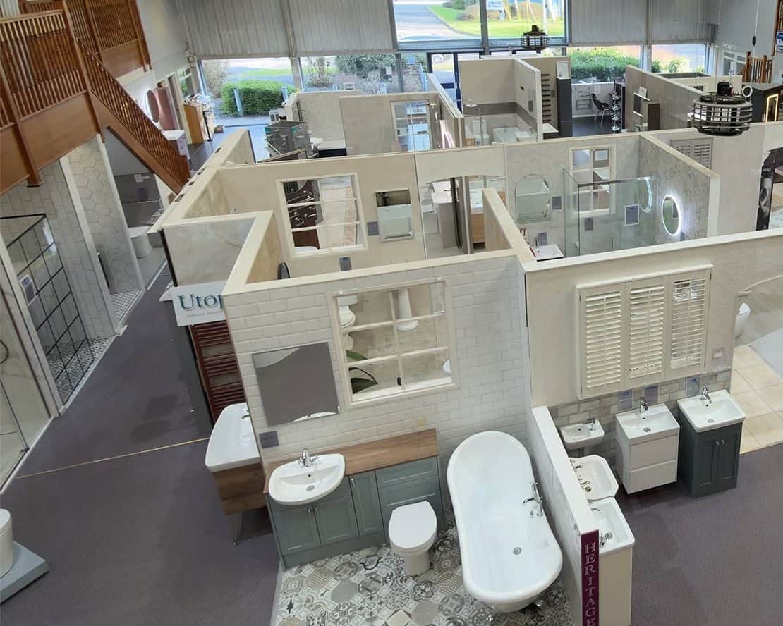 TW Thomas showroom floor seen from the mezzanine, with room-set bathroom displays
