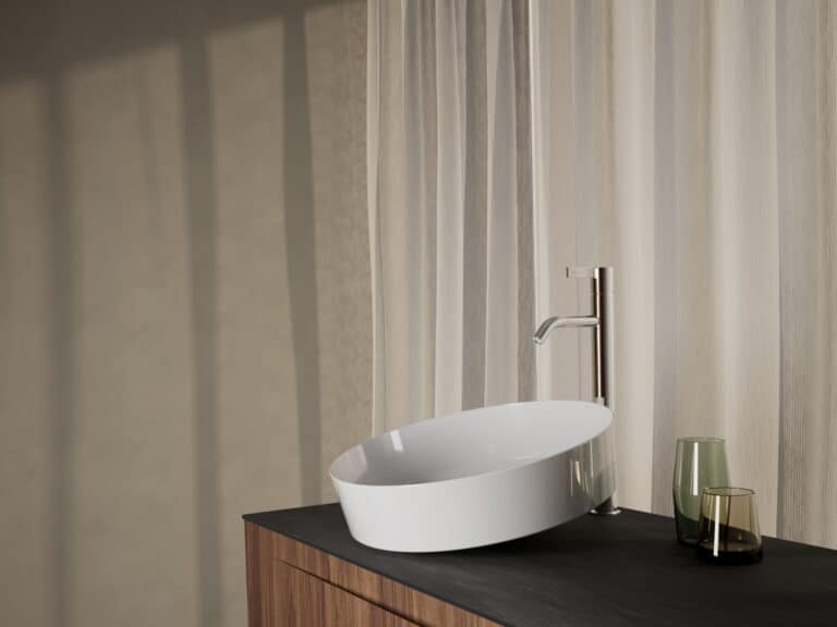 Laufen white oval countertop washbasin on a walnut vanity unit with a tall chrome mixer