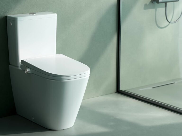 Laufen Cleanet Meda close-coupled shower toilet in a sage green bathroom