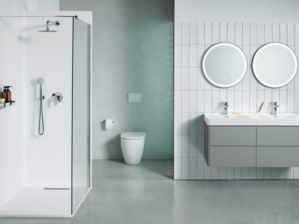 Laufen Pro X walk-in shower and wall-hung WC with Base 2.0 twin washbasins and two round mirrors