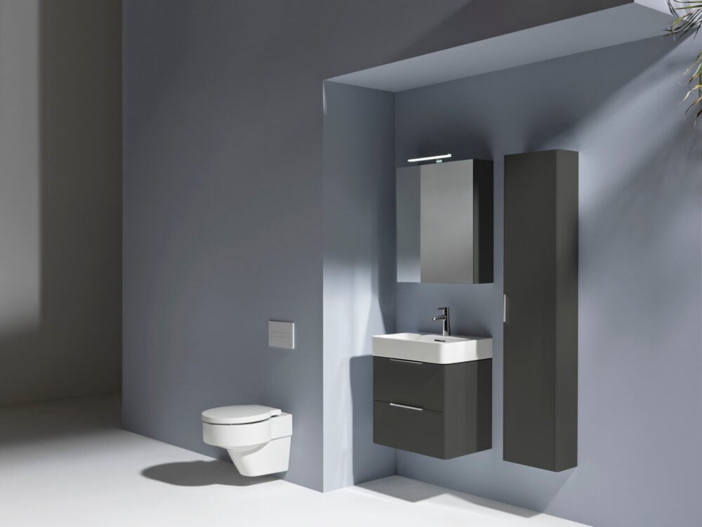 Laufen VAL washbasin on a graphite Base vanity unit with a mirror cabinet, over-mirror light and tall cabinet in a blue-grey bathroom