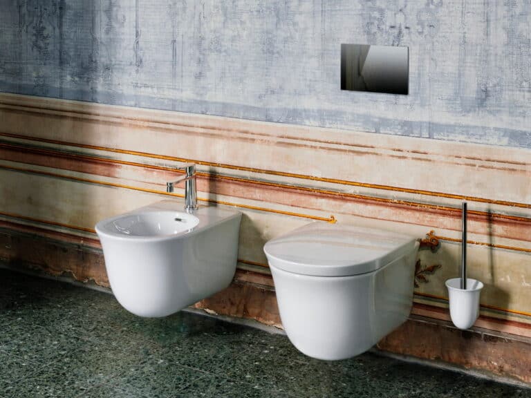Laufen The New Classic wall-hung WC and bidet against a painted period wall above a green marble plinth