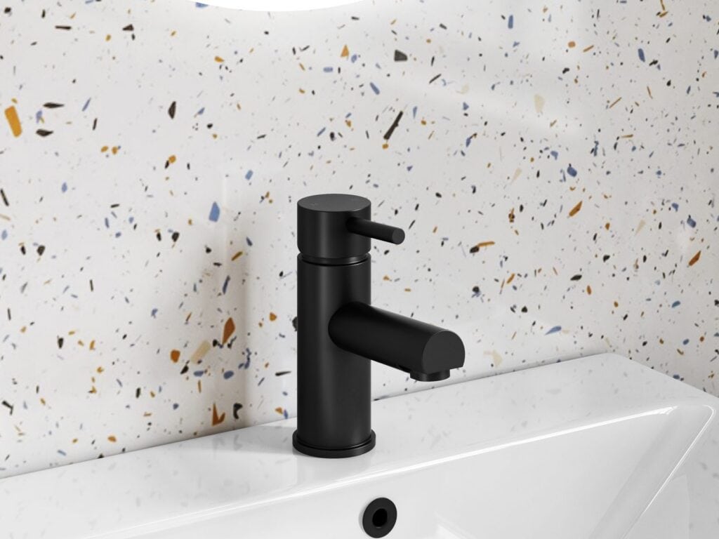 Modern matt black basin mixer tap against terrazzo tiles