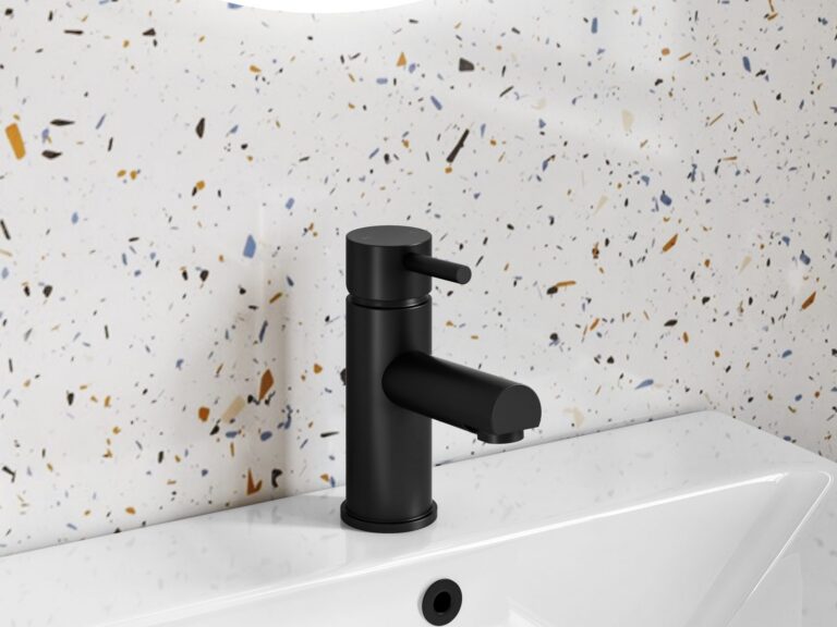 Modern matt black basin mixer tap against terrazzo tiles