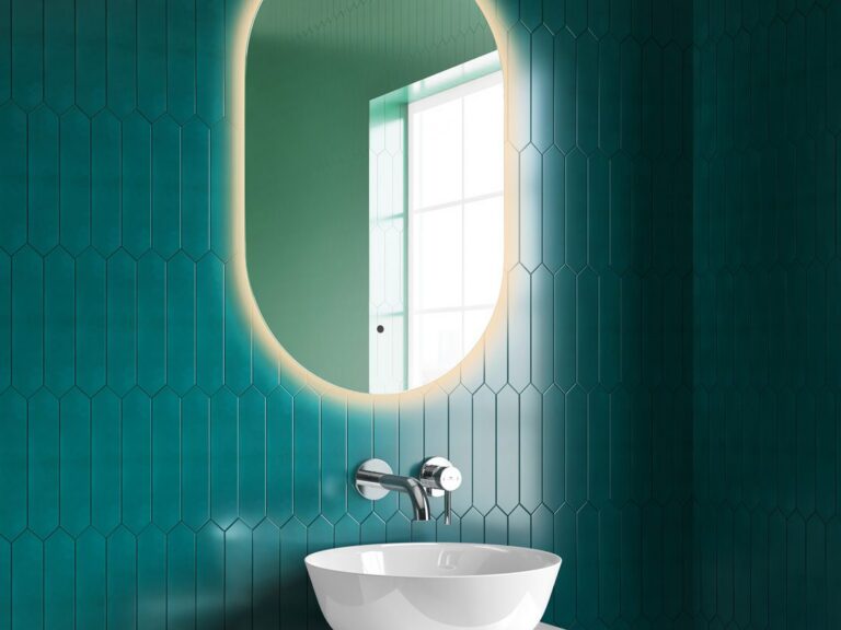 MyLife Finn illuminated LED mirror with warm glow above a round basin on green tiles
