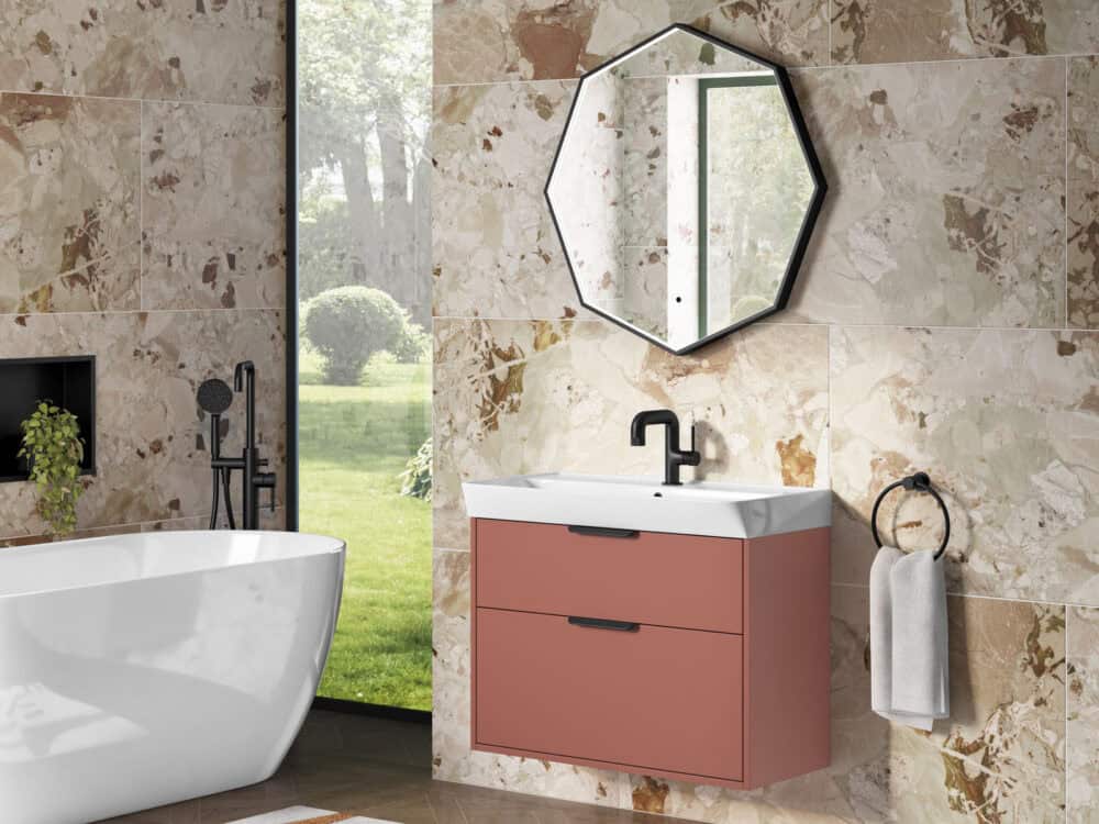 MyLife Calia soft terracotta wall-hung vanity with an octagonal mirror beside a freestanding bath and garden window