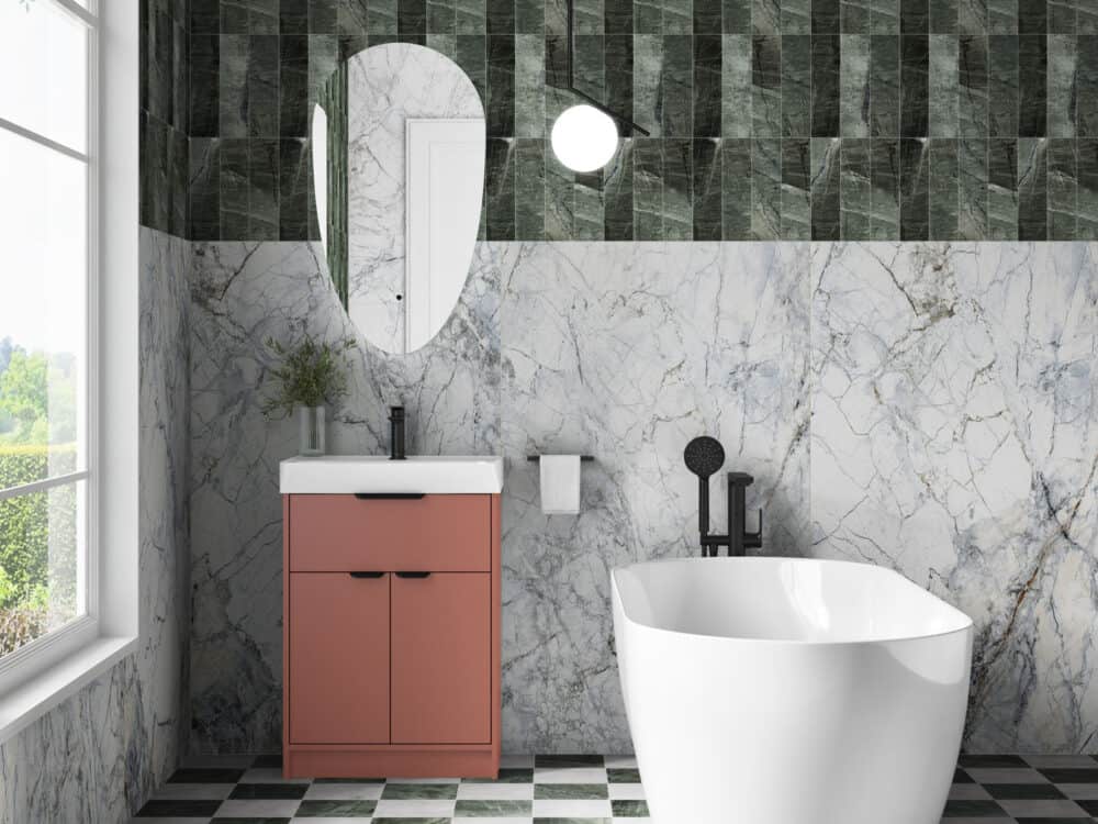 MyLife Calia terracotta floor-standing vanity against green tiles with a chequerboard floor and freestanding bath