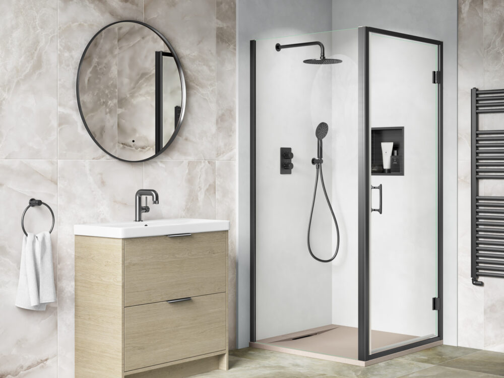 MyLife Edyn light oak floor-standing vanity with a round mirror beside a black-framed walk-in shower