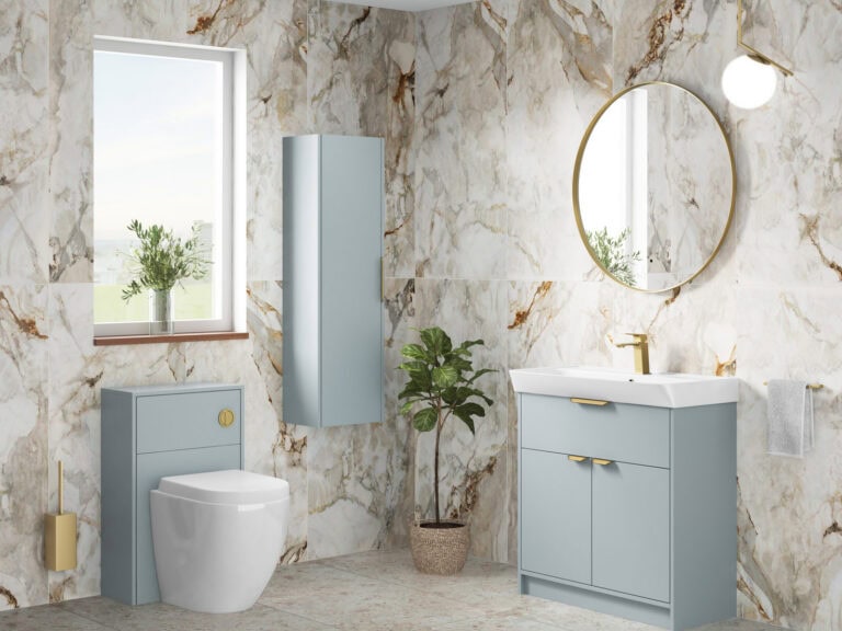 MyLife Calia tempered grey floor-standing vanity unit and tall cabinet with a round mirror in a marble bathroom
