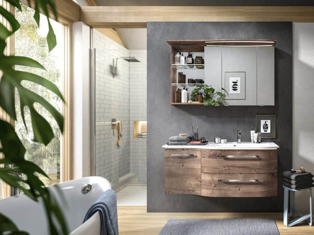 Pelipal wood-finish vanity unit and mirror cabinet in a bathroom with a walk-in shower