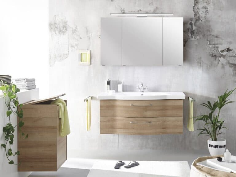 Pelipal illuminated mirror cabinet above a wall-hung oak vanity unit