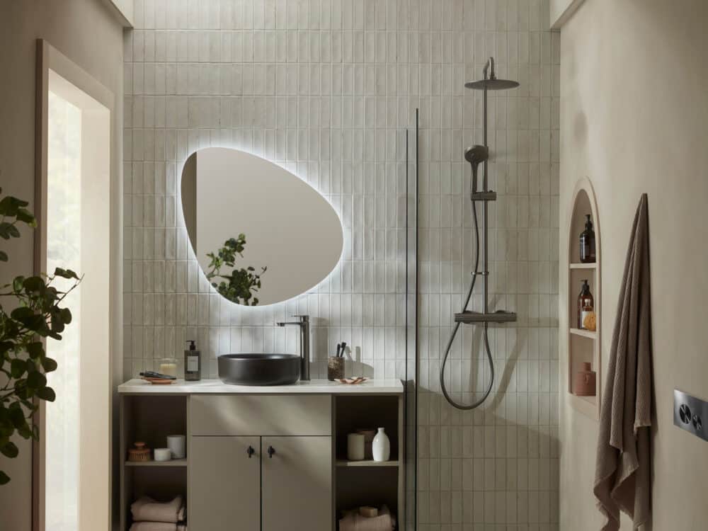 An R2 Muse fitted furniture run in stone grey with a black countertop basin beside a walk-in shower